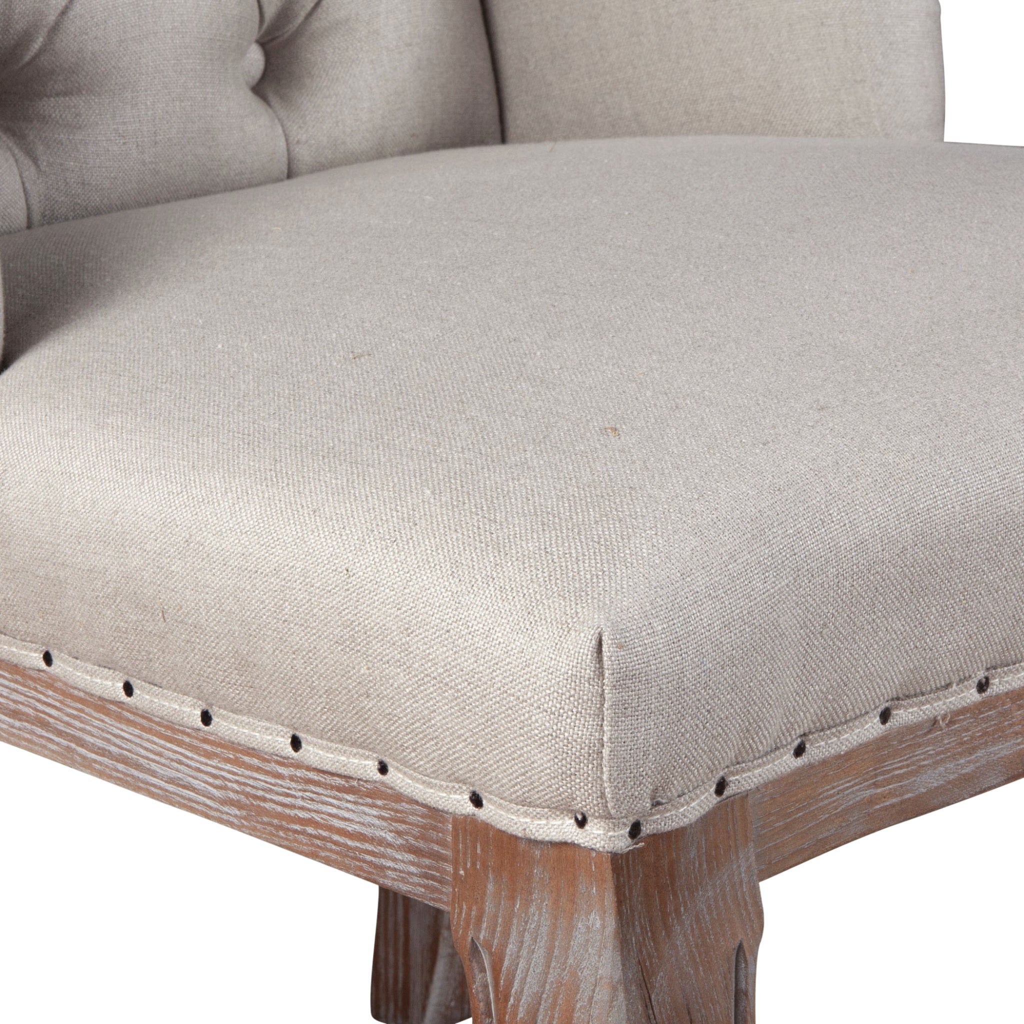 French country-style dining chair with tufted linen upholstery and distressed wood legs