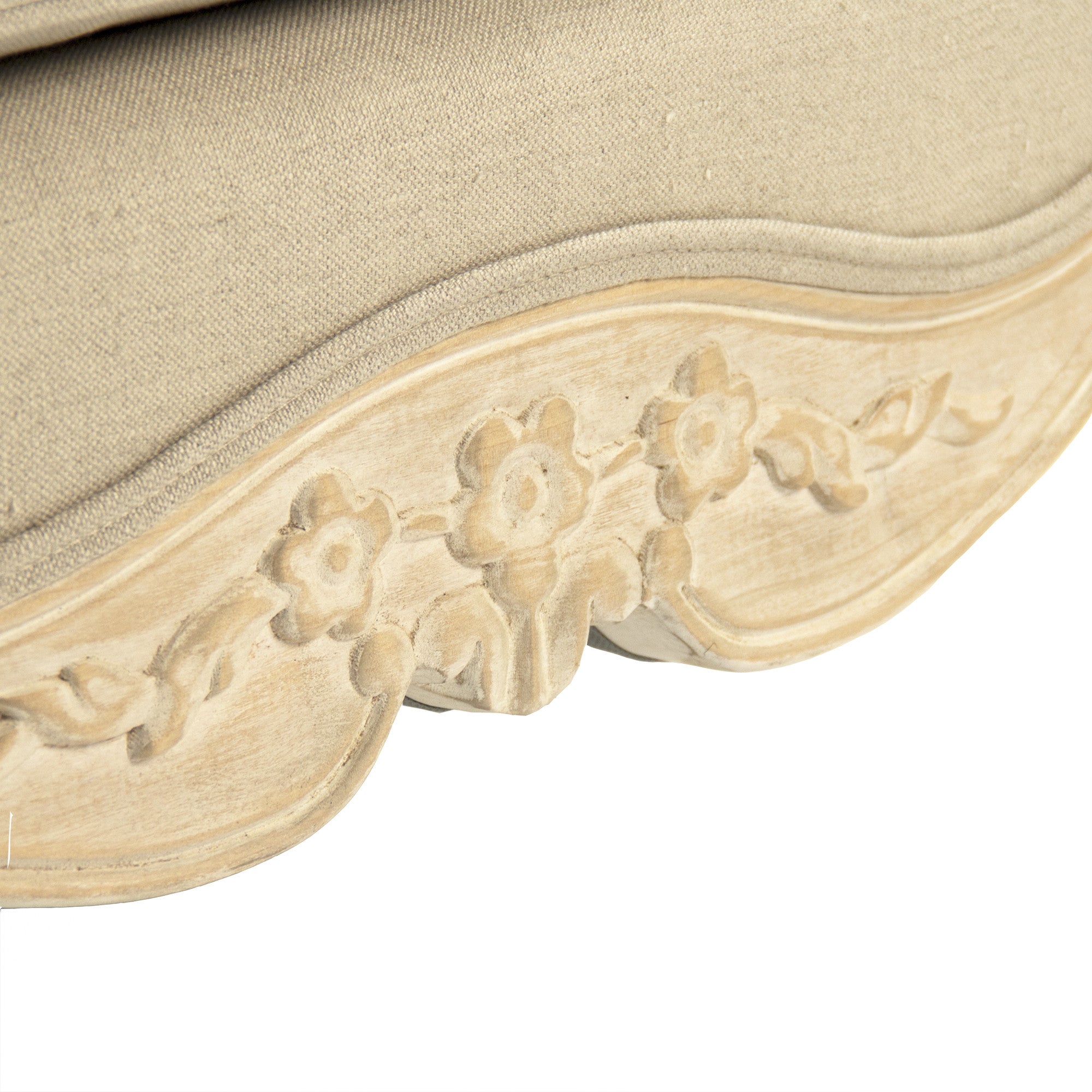 Close-up view of Colbey Chair’s delicate carved floral accents on the wooden frame