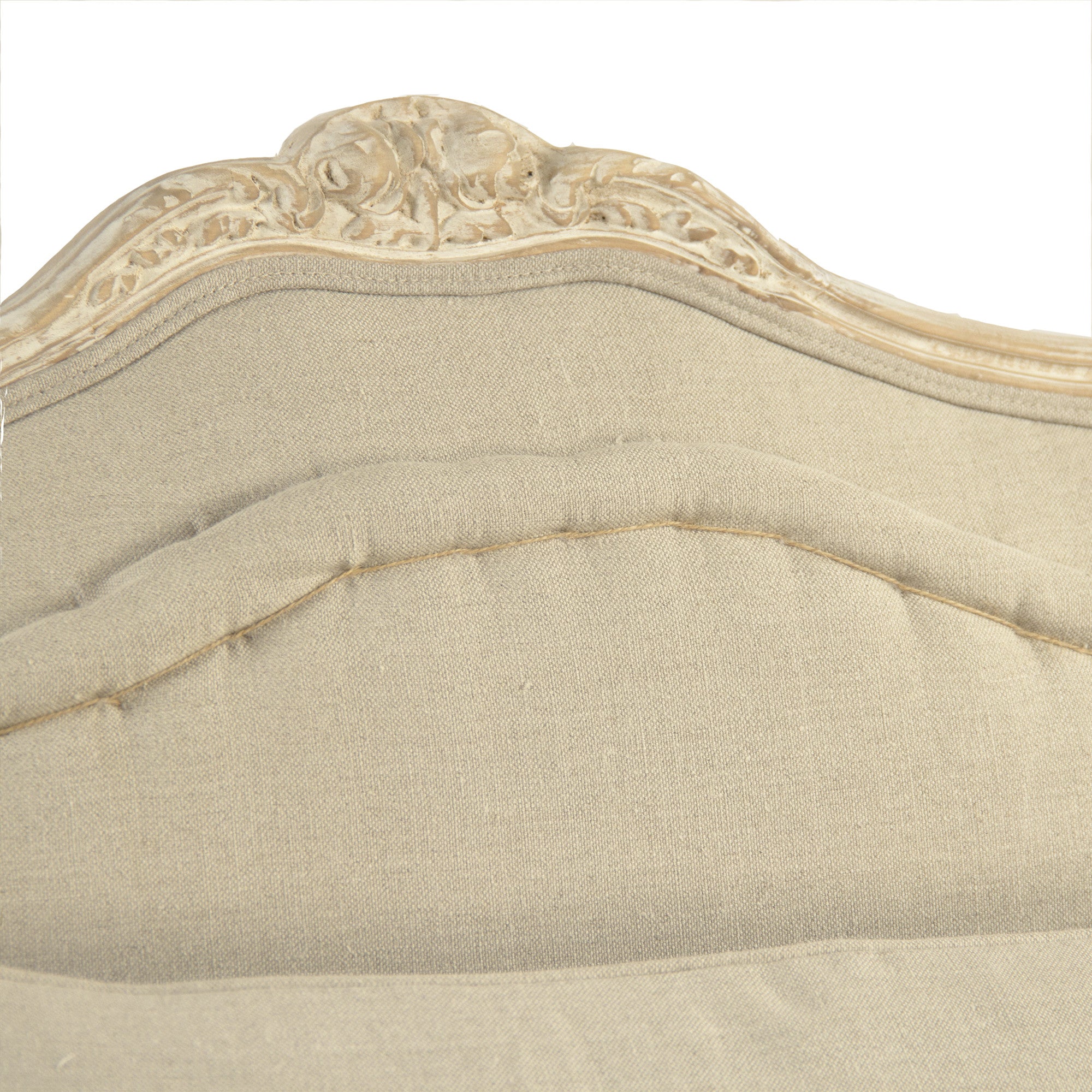 Close-up of the Colbey Chair's hand-stitched detailing and carved floral accents