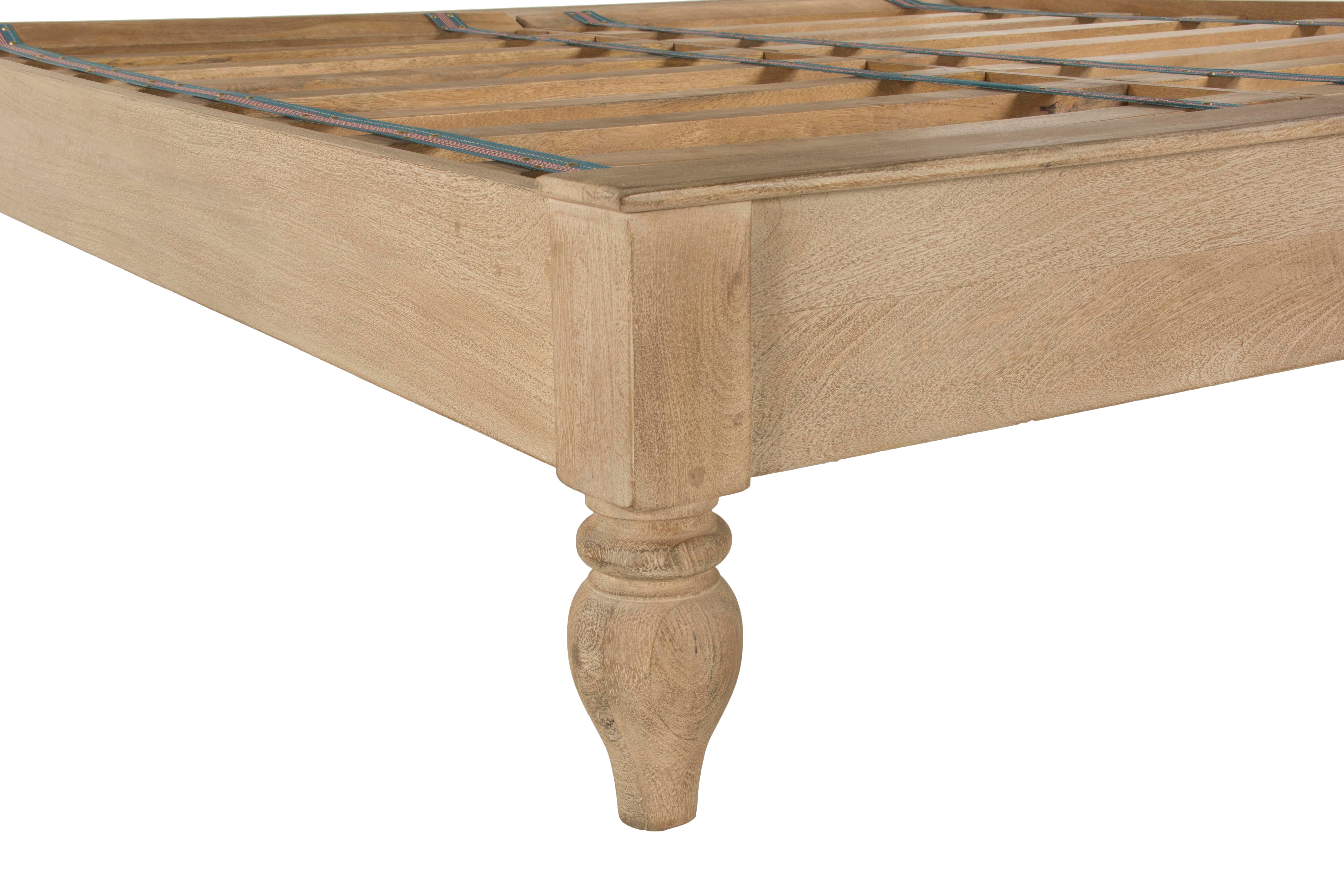 Elegant mango wood bed with hand-turned legs and decorative carvings