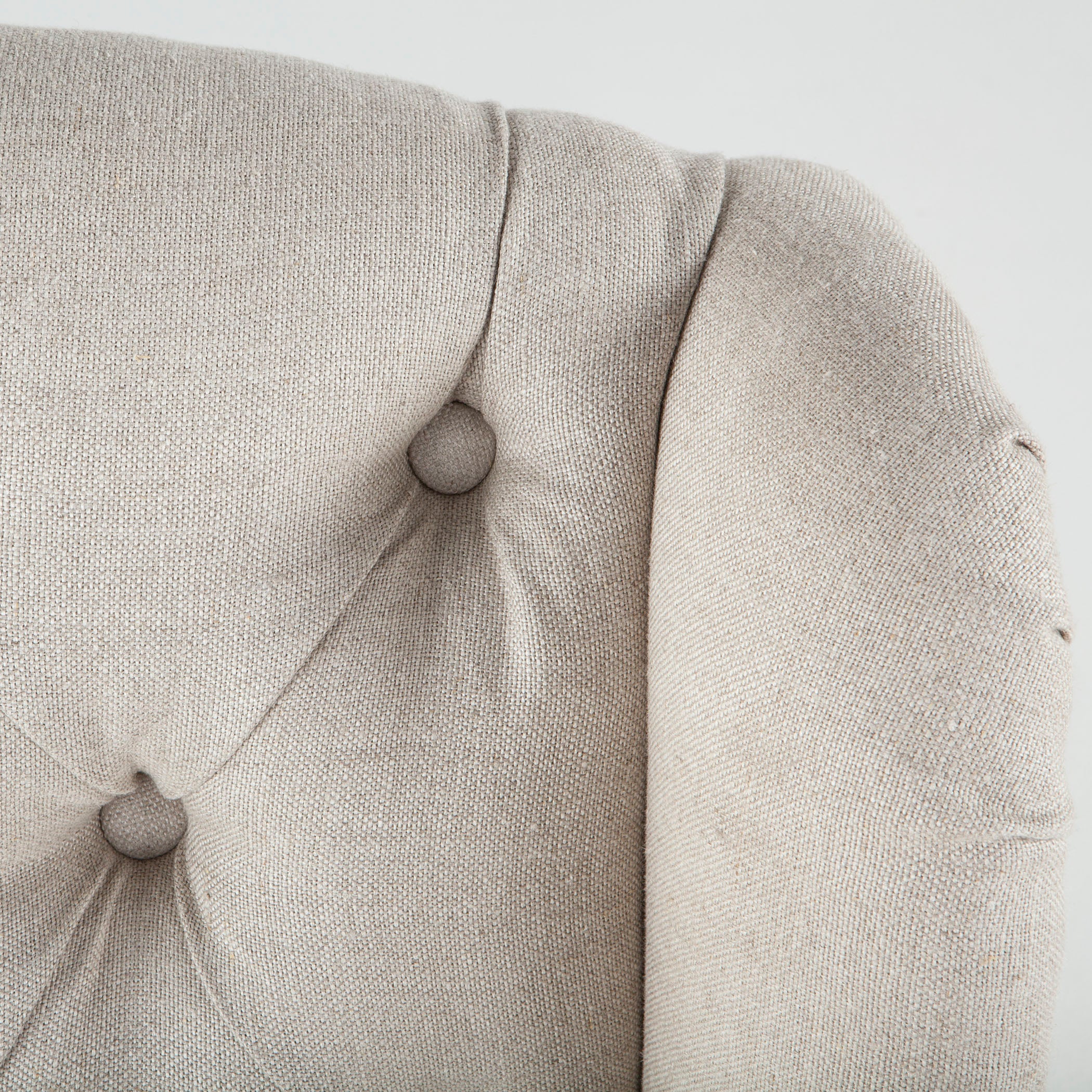 Classic dining chair with deconstructed oak frame, off-white upholstery, and button tufting