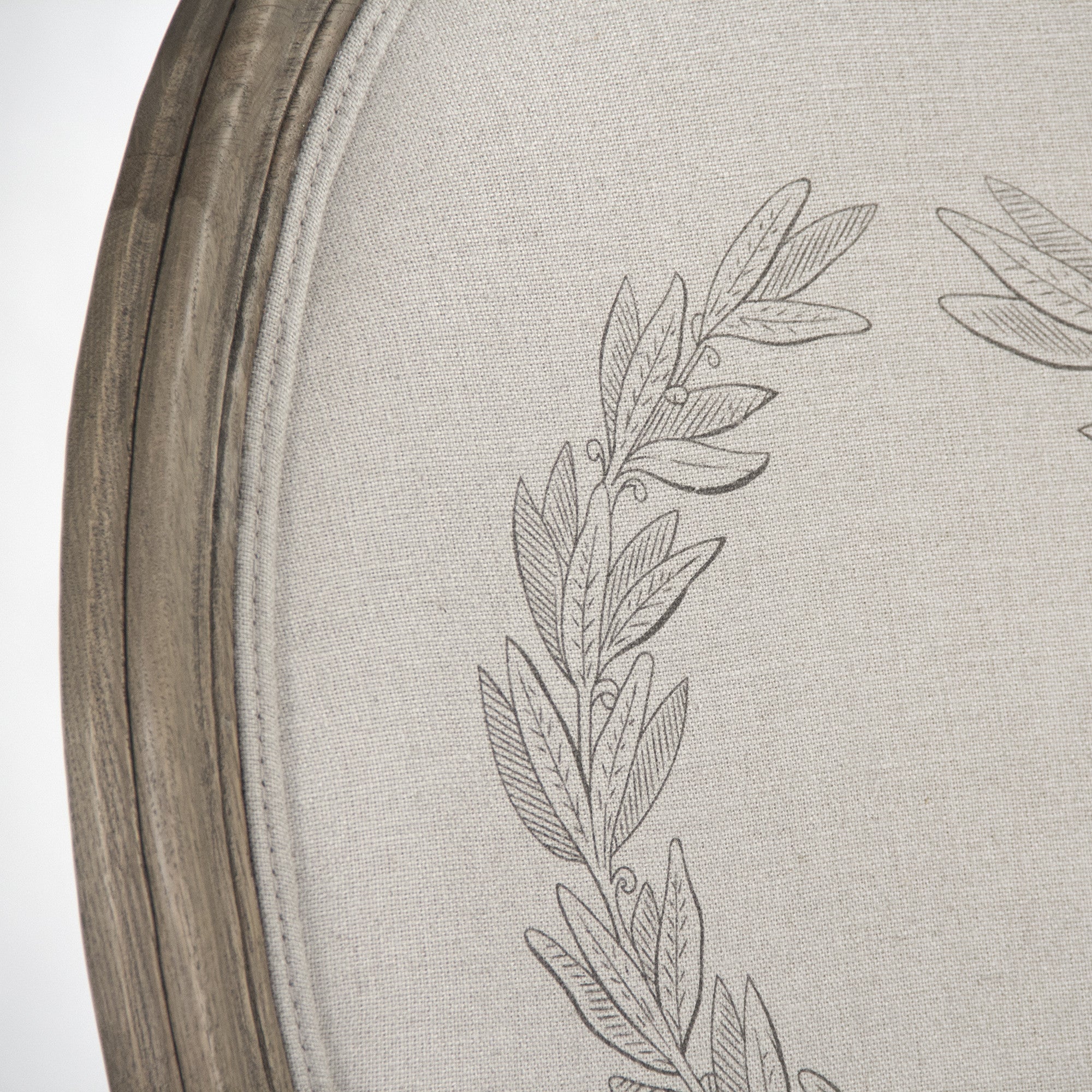 Close-up of natural linen fabric with stylist wreath design on side chair backrest