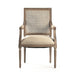 A classic French-style armchair with a distressed gray-brown wood frame, a woven cane backrest, and a light beige upholstered seat cushion, shown against a plain white background.