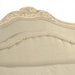 Close-up of the Colbey Chair's hand-stitched detailing and carved floral accents