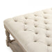 French country style ottoman with tufted top and neutral cream fabric.